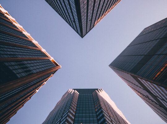 low-angle photography of four high-rise buildings